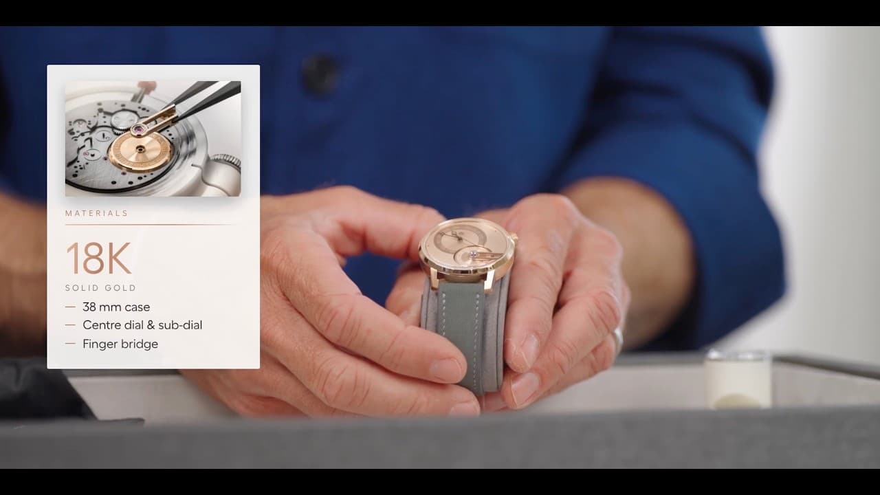 A person holds a small gold wristwatch over a table, with an inset card listing materials and case details.